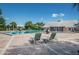 Relax by the community pool, surrounded by palm trees and lounge chairs for ultimate comfort at 5094 Starfish Se Dr # E, St Petersburg, FL 33705