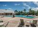 Relax by the community pool, surrounded by palm trees and lounge chairs for ultimate comfort at 5094 Starfish Se Dr # E, St Petersburg, FL 33705