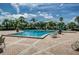 Enjoy the community pool with clear water, lounge chairs, and a beautifully landscaped area with palm trees at 5094 Starfish Se Dr # E, St Petersburg, FL 33705