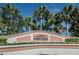 Waterside at Coquina Key South community sign surrounded by lush tropical landscaping and palm trees against a clear blue sky at 5094 Starfish Se Dr # E, St Petersburg, FL 33705