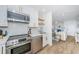 Contemporary kitchen featuring stainless steel appliances and open design, connected to the living area at 5094 Starfish Se Dr # E, St Petersburg, FL 33705