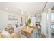 Bright and airy living room with modern decor, a ceiling fan, and a view of the waterfront at 5094 Starfish Se Dr # E, St Petersburg, FL 33705
