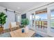 Relaxing living room with deck access, barn door, and stylish furnishings, offering serene waterfront views at 5094 Starfish Se Dr # E, St Petersburg, FL 33705