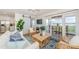 Cozy living room featuring sliding glass doors to deck, modern decor, ceiling fan, and open floor plan at 5094 Starfish Se Dr # E, St Petersburg, FL 33705