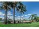 Scenic view of the tennis courts surrounded by lush greenery and palm trees in the community at 5094 Starfish Se Dr # E, St Petersburg, FL 33705