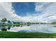 Scenic water view featuring calm lake and lush green landscape and waterfront condos at 5094 Starfish Se Dr # E, St Petersburg, FL 33705