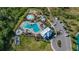 Aerial view showcasing community pool with surrounding lounge chairs, a kiddie pool, and a playground at 5108 Suncatcher Dr, Wesley Chapel, FL 33545