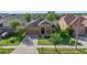 Aerial view of home with well-maintained landscaping, concrete driveway, and sidewalks at 5108 Suncatcher Dr, Wesley Chapel, FL 33545