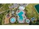 Aerial image of the community pool featuring an expansive pool area, kiddie pool, playground and lounging area at 5108 Suncatcher Dr, Wesley Chapel, FL 33545