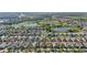 Aerial view of the neighborhood featuring multiple ponds, mature trees and landscaping at 5108 Suncatcher Dr, Wesley Chapel, FL 33545