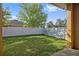 View of the spacious back yard with green grass and white vinyl fence at 5108 Suncatcher Dr, Wesley Chapel, FL 33545