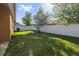 The property features a large, grassy back yard with a white privacy fence at 5108 Suncatcher Dr, Wesley Chapel, FL 33545