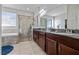 Primary bathroom with double vanities, walk-in shower, and a soaking tub at 5108 Suncatcher Dr, Wesley Chapel, FL 33545