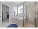 Bright bathroom featuring a walk-in shower and a soaking tub beneath a window at 5108 Suncatcher Dr, Wesley Chapel, FL 33545