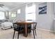 Cozy breakfast nook with a round table and chairs, complemented by natural light and a comfortable sectional at 5108 Suncatcher Dr, Wesley Chapel, FL 33545