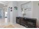 Hallway featuring tiled floors, modern decor, a stylish mirror, and tasteful wall art at 5108 Suncatcher Dr, Wesley Chapel, FL 33545