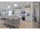 Bright kitchen with white cabinets, stainless appliances, quartz countertops, and a convenient breakfast bar at 5108 Suncatcher Dr, Wesley Chapel, FL 33545