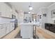 Beautiful kitchen with white cabinets, stainless steel appliances, quartz countertops, and stylish barstool seating at 5108 Suncatcher Dr, Wesley Chapel, FL 33545