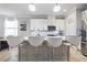 Modern kitchen with white cabinets, stainless steel appliances, a breakfast bar, and pendant lighting at 5108 Suncatcher Dr, Wesley Chapel, FL 33545