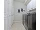 Laundry room features front-loading washer and dryer with overhead cabinets for storage at 5108 Suncatcher Dr, Wesley Chapel, FL 33545
