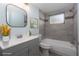 Stylishly staged bathroom with modern vanity, tub-shower combo, and soft blue walls at 5203 Overton Dr, New Port Richey, FL 34652