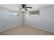 Bright bedroom with tile flooring, two windows and a ceiling fan at 5203 Overton Dr, New Port Richey, FL 34652