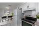 Staged Kitchen featuring stainless appliances, granite counters, bright lighting, and tile flooring at 5203 Overton Dr, New Port Richey, FL 34652