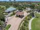 Aerial view of a community entrance with lush landscaping and a glimpse of the clubhouse at 6113 Kipps Colony W Dr, Gulfport, FL 33707