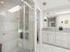 Elegant bathroom with a glass-enclosed shower, marble countertop, and modern fixtures at 6113 Kipps Colony W Dr, Gulfport, FL 33707