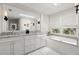 Clean bathroom featuring a bathtub, large mirrors, dual sinks, and bright lighting at 6113 Kipps Colony W Dr, Gulfport, FL 33707