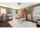 Charming bedroom with green walls, white trim, a crib, and multiple windows at 6113 Kipps Colony W Dr, Gulfport, FL 33707