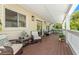 Relaxing covered deck with wicker furniture and potted plants at 6113 Kipps Colony W Dr, Gulfport, FL 33707