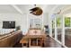 Open dining room with custom lighting, wood floors, and sliding doors to an outdoor seating area at 6113 Kipps Colony W Dr, Gulfport, FL 33707