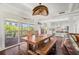 Dining room with custom lighting, wood floors, and sliding doors to an outdoor seating area at 6113 Kipps Colony W Dr, Gulfport, FL 33707