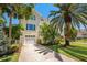 Charming two-story home with a garage, well-manicured lawn, and lush landscaping at 6113 Kipps Colony W Dr, Gulfport, FL 33707