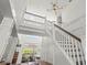 Bright foyer featuring a grand staircase, custom lighting, and access to the main living area at 6113 Kipps Colony W Dr, Gulfport, FL 33707
