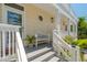 A welcoming front porch features a charming bench and offers a glimpse of a cozy entryway at 6113 Kipps Colony W Dr, Gulfport, FL 33707