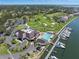 Scenic aerial view of a golf course, clubhouse, and marina in a premier community at 6113 Kipps Colony W Dr, Gulfport, FL 33707