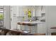 Open kitchen with marble counters, breakfast bar, stainless appliances, and view of the living area at 6113 Kipps Colony W Dr, Gulfport, FL 33707
