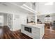 Bright kitchen features a center island, marble countertops, stainless appliances, and hardwood floors at 6113 Kipps Colony W Dr, Gulfport, FL 33707