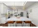 Beautiful kitchen with white cabinets, a marble island, and elegant pendant lighting at 6113 Kipps Colony W Dr, Gulfport, FL 33707