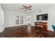 Large living room featuring wood floors, natural light, and media center with a piano at 6113 Kipps Colony W Dr, Gulfport, FL 33707