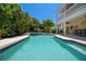 Beautiful backyard pool with a built-in spa and manicured landscaping, perfect for outdoor relaxation at 6113 Kipps Colony W Dr, Gulfport, FL 33707