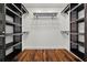 Spacious walk-in closet with custom shelving and hardwood floors for organized storage at 6113 Kipps Colony W Dr, Gulfport, FL 33707
