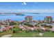 Stunning aerial view of the condo complex with water views, lush landscaping, and golf course at 6322 Palma Del Mar S Blvd # 706, St Petersburg, FL 33715
