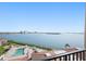 Scenic view from the balcony overlooking a pool and expansive waterfront with buildings on the horizon at 6322 Palma Del Mar S Blvd # 706, St Petersburg, FL 33715