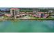 Aerial view showcasing the waterfront condo community with a swimming pool and lush surroundings at 6322 Palma Del Mar S Blvd # 706, St Petersburg, FL 33715