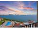 Breathtaking balcony view of the tranquil waterfront, city skyline, and community pool at 6322 Palma Del Mar S Blvd # 706, St Petersburg, FL 33715