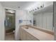 Bathroom with an extended countertop, large mirror, shower, and linen closet at 6322 Palma Del Mar S Blvd # 706, St Petersburg, FL 33715