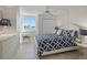 Bedroom with a patterned bed, side tables, water view, and ample natural light at 6322 Palma Del Mar S Blvd # 706, St Petersburg, FL 33715